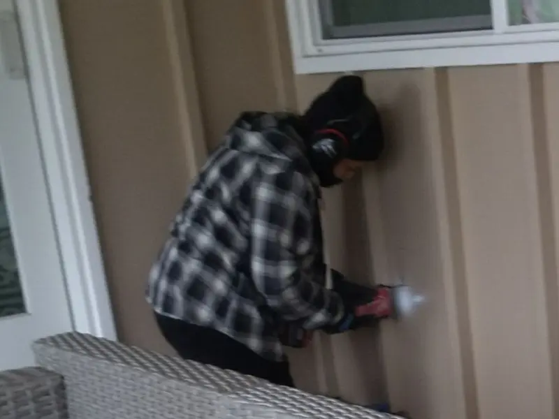 Professional electrician installing an exterior outlet in Hamburg